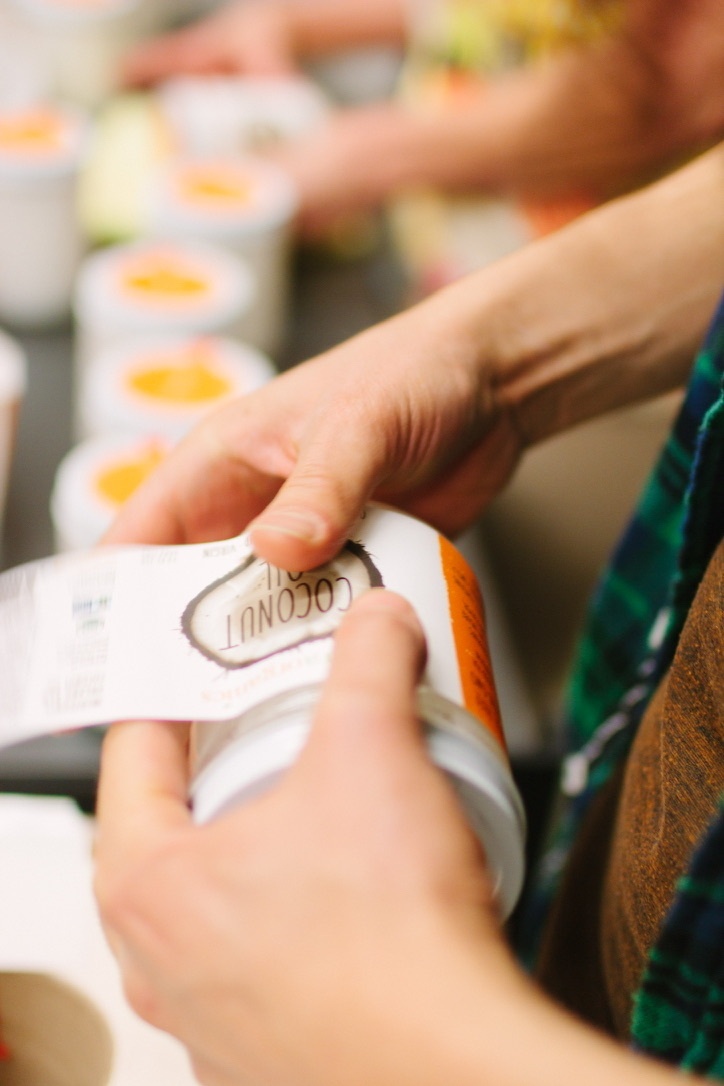 Coconut Oil Jar Being Labeled